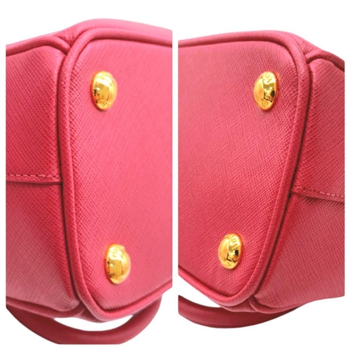 101 - A Prada Saffiano Vernice Galleria Handbag. Pink cross-grain saffiano leather exterior, gold-toned ha... 