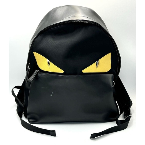 108 - A Fendi Black Monster Backpack. Textile and leather exterior, with two large yellow monster eyes, a ... 