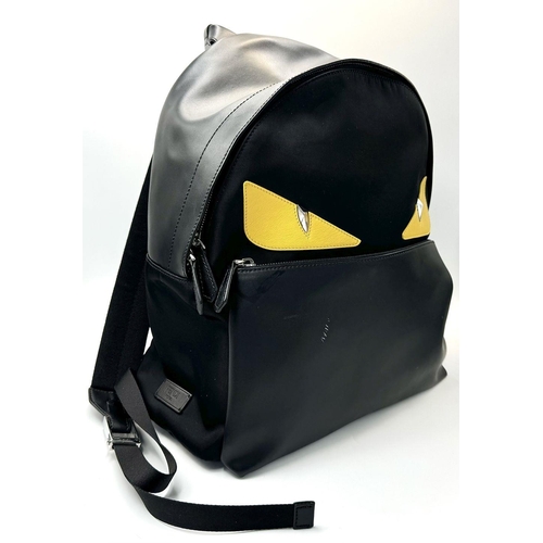 108 - A Fendi Black Monster Backpack. Textile and leather exterior, with two large yellow monster eyes, a ... 