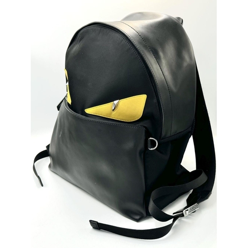 108 - A Fendi Black Monster Backpack. Textile and leather exterior, with two large yellow monster eyes, a ... 