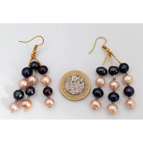 119 - A three-row necklace with black and pink cultured pearls accompanied by matching earrings. Necklace ... 