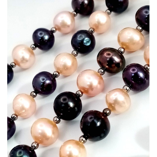 119 - A three-row necklace with black and pink cultured pearls accompanied by matching earrings. Necklace ... 