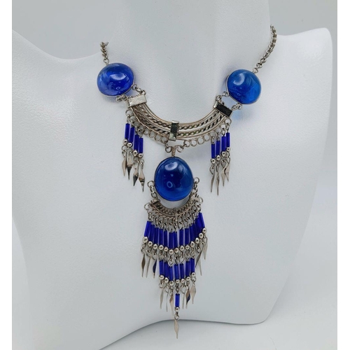 126 - A white metal (untested) necklace and earrings set in the style of Native American tradition, in a p... 