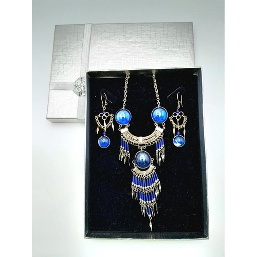 126 - A white metal (untested) necklace and earrings set in the style of Native American tradition, in a p... 