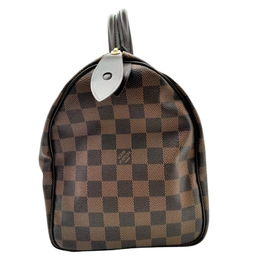 129 - A Louis Vuitton Damier Ebene Speedy Thirty Bag. Brown Damier Ebene canvas exterior with gold-toned h... 