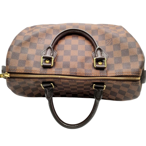 129 - A Louis Vuitton Damier Ebene Speedy Thirty Bag. Brown Damier Ebene canvas exterior with gold-toned h... 