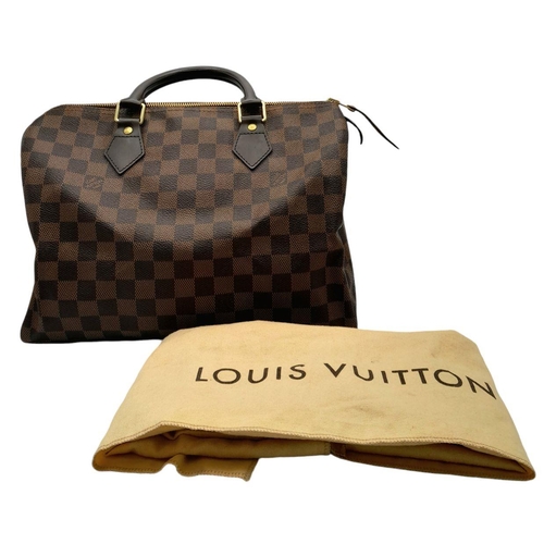 129 - A Louis Vuitton Damier Ebene Speedy Thirty Bag. Brown Damier Ebene canvas exterior with gold-toned h... 