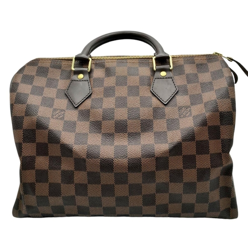 129 - A Louis Vuitton Damier Ebene Speedy Thirty Bag. Brown Damier Ebene canvas exterior with gold-toned h... 