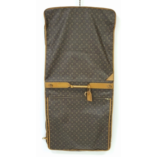 143 - A Louis Vuitton Suit Luggage Bag. Monogram canvas exterior. Brown leather trim and gold tone hardwar... 