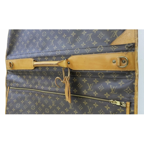 143 - A Louis Vuitton Suit Luggage Bag. Monogram canvas exterior. Brown leather trim and gold tone hardwar... 