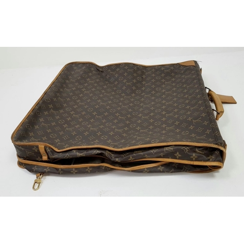 143 - A Louis Vuitton Suit Luggage Bag. Monogram canvas exterior. Brown leather trim and gold tone hardwar... 