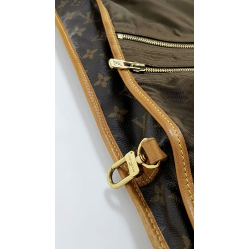 143 - A Louis Vuitton Suit Luggage Bag. Monogram canvas exterior. Brown leather trim and gold tone hardwar... 