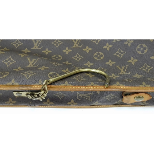 143 - A Louis Vuitton Suit Luggage Bag. Monogram canvas exterior. Brown leather trim and gold tone hardwar... 