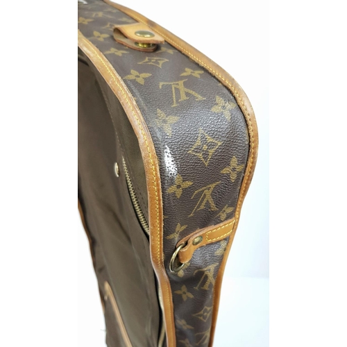 143 - A Louis Vuitton Suit Luggage Bag. Monogram canvas exterior. Brown leather trim and gold tone hardwar... 