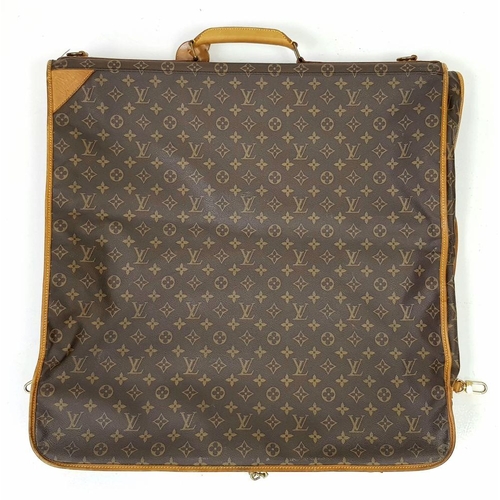 143 - A Louis Vuitton Suit Luggage Bag. Monogram canvas exterior. Brown leather trim and gold tone hardwar... 