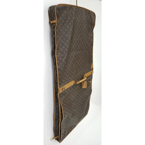 143 - A Louis Vuitton Suit Luggage Bag. Monogram canvas exterior. Brown leather trim and gold tone hardwar... 