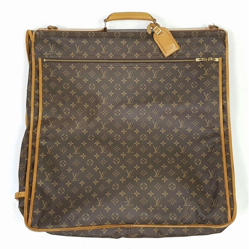 143 - A Louis Vuitton Suit Luggage Bag. Monogram canvas exterior. Brown leather trim and gold tone hardwar... 