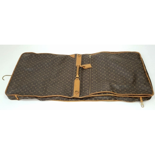 143 - A Louis Vuitton Suit Luggage Bag. Monogram canvas exterior. Brown leather trim and gold tone hardwar... 