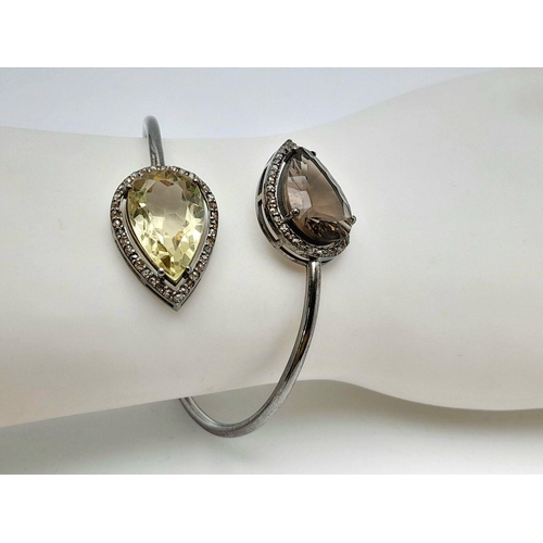 1492 - A Citrine and Smoky Quartz Cuff Bangle. Set in 925 Sterling silver. HV 2330. 12.9g total weight.