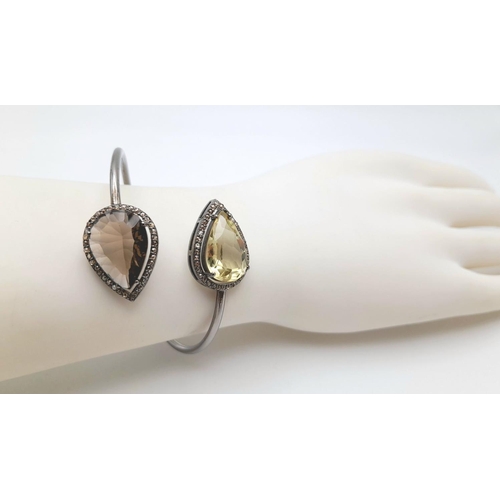 1492 - A Citrine and Smoky Quartz Cuff Bangle. Set in 925 Sterling silver. HV 2330. 12.9g total weight.