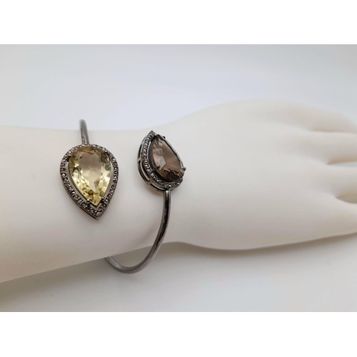 1492 - A Citrine and Smoky Quartz Cuff Bangle. Set in 925 Sterling silver. HV 2330. 12.9g total weight.