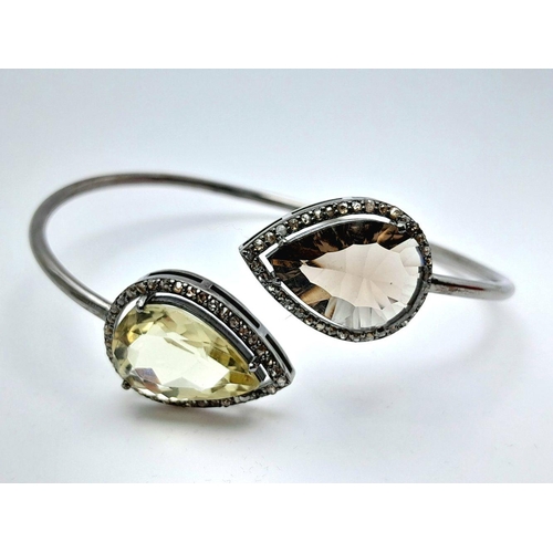 1492 - A Citrine and Smoky Quartz Cuff Bangle. Set in 925 Sterling silver. HV 2330. 12.9g total weight.