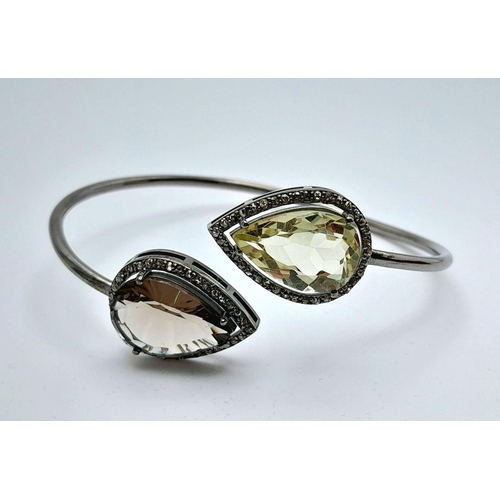 1492 - A Citrine and Smoky Quartz Cuff Bangle. Set in 925 Sterling silver. HV 2330. 12.9g total weight.