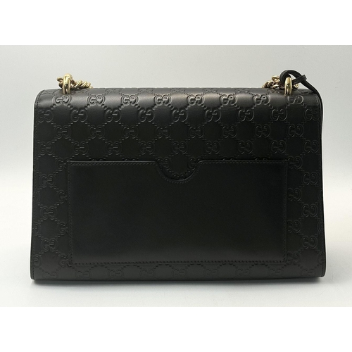 150 - A Gucci Guccissima Padlock Shoulder Bag. Guccissima monogram-embossed black leather exterior with go... 