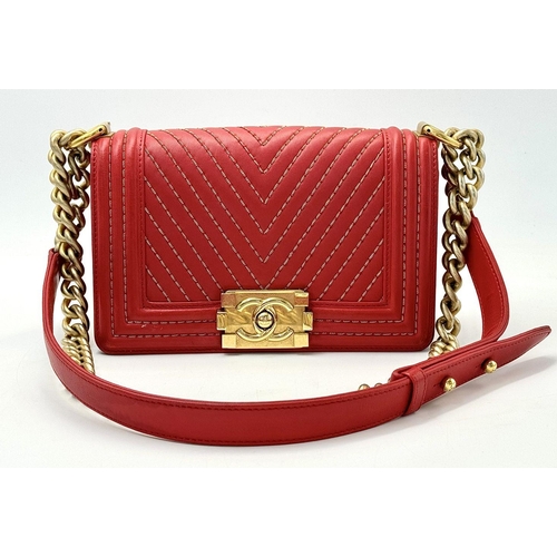 18 - A Chanel Lambskin Chevron Chain Stitched Boy Flap Bag. Red leather exterior features a chevron quilt... 