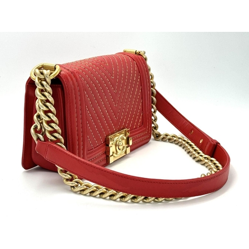 18 - A Chanel Lambskin Chevron Chain Stitched Boy Flap Bag. Red leather exterior features a chevron quilt... 