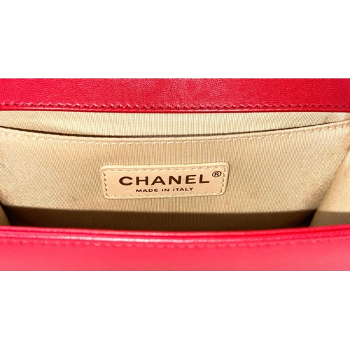 18 - A Chanel Lambskin Chevron Chain Stitched Boy Flap Bag. Red leather exterior features a chevron quilt... 