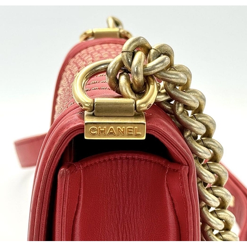 18 - A Chanel Lambskin Chevron Chain Stitched Boy Flap Bag. Red leather exterior features a chevron quilt... 