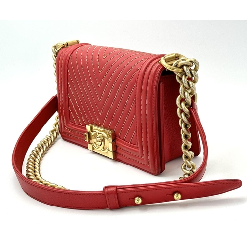 18 - A Chanel Lambskin Chevron Chain Stitched Boy Flap Bag. Red leather exterior features a chevron quilt... 