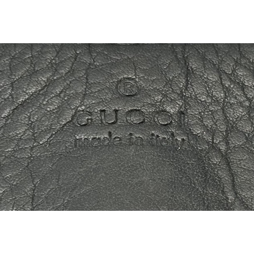 235 - A Gucci Black Bamboo Handle Tote Bag. Black leather exterior with bamboo handles, gold-toned hardwar... 