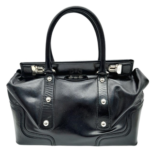 277 - A Dolce & Gabbana Black Patent Leather Bag. Leather exterior with silver-tone hardware, protective m... 