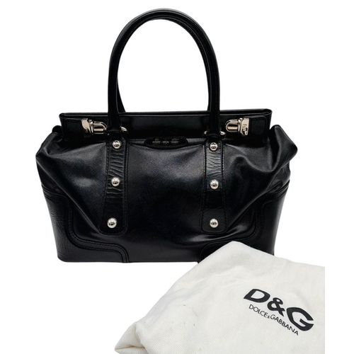 277 - A Dolce & Gabbana Black Patent Leather Bag. Leather exterior with silver-tone hardware, protective m... 