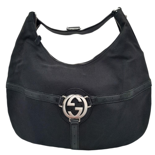 284 - A Gucci Black Canvas and Leather Hobo Bag. Black canvas and leather exterior with silver-toned hardw... 