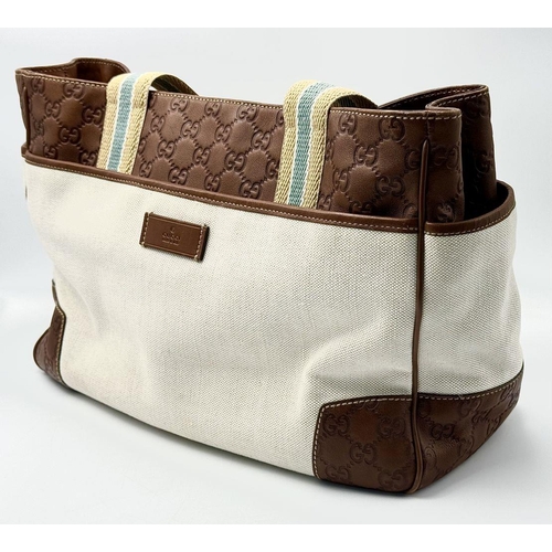 361 - A Vintage Gucci Canvas Shoulder Bag. Beige canvas exterior with brown leather trim, gold-toned hardw... 