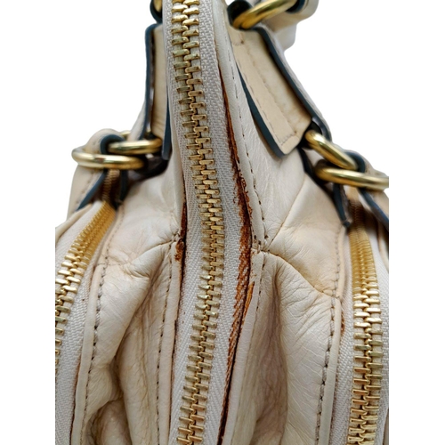 375 - A Chloe Seekins Precisions Handbag. Quilted cream leather exterior with gold-toned hardware. Feature... 