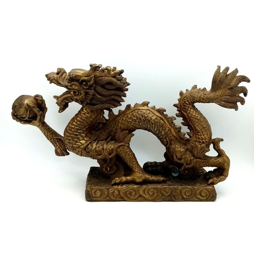 380 - A Large Antique Chinese Bronze of a Dragon Chasing the Pearl. Excellent casting and detail. Height -... 