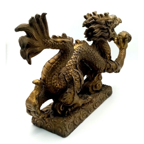 380 - A Large Antique Chinese Bronze of a Dragon Chasing the Pearl. Excellent casting and detail. Height -... 