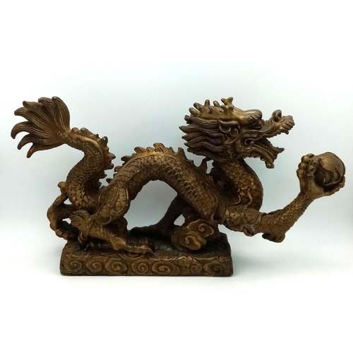 380 - A Large Antique Chinese Bronze of a Dragon Chasing the Pearl. Excellent casting and detail. Height -... 