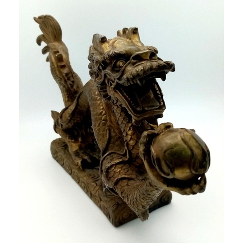 380 - A Large Antique Chinese Bronze of a Dragon Chasing the Pearl. Excellent casting and detail. Height -... 