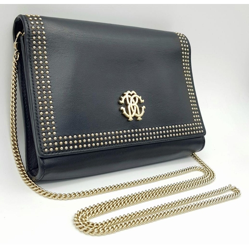 389 - A Roberto Cavalli Small Black Leather Crossbody Bag. Exterior stud and monogram decoration. Gold ton... 