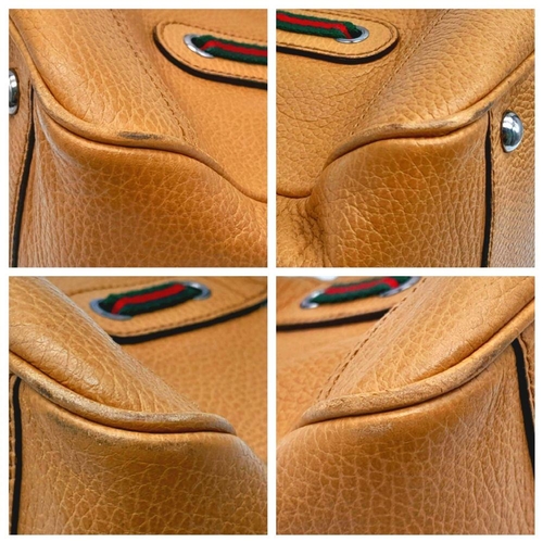 416 - A Gucci Brown Leather Sausage Bag. Textured exterior. Textile interior with zipped and open compartm... 