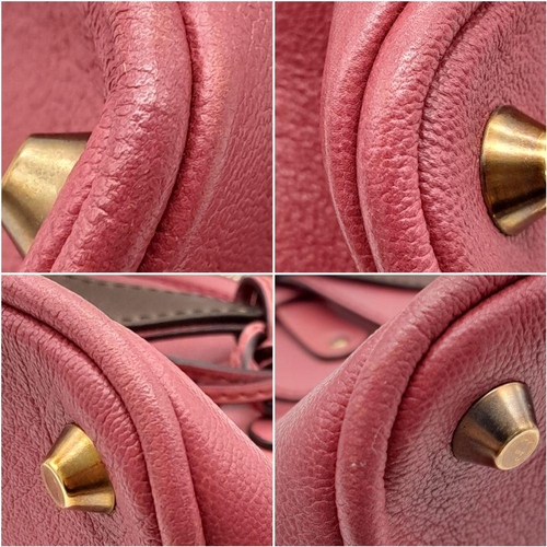 430 - A Chloe Fuchsia Leather Charm Detail Tote Bag. Pink leather exterior with gold-tone hardware and a d... 