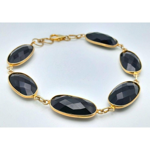 435 - A Black Onyx Gold plated Silver Bracelet. 18cm. 12.7g total weight. HV 2420