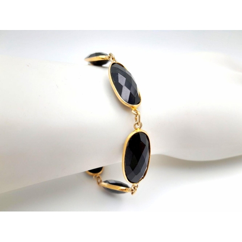 435 - A Black Onyx Gold plated Silver Bracelet. 18cm. 12.7g total weight. HV 2420