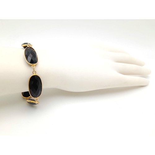 435 - A Black Onyx Gold plated Silver Bracelet. 18cm. 12.7g total weight. HV 2420