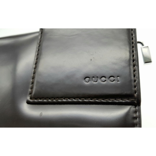 437 - A Gucci Brown Leather Shoulder Bag. Leather exterior with silver-tone hardware and a magnetic snap c... 